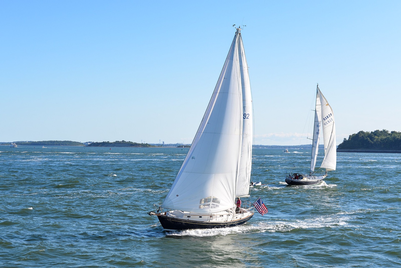 Two sloops sailing in Boston Harbor in late August